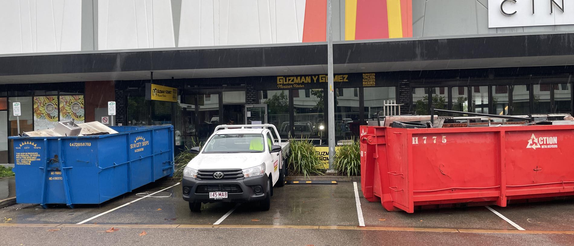 The Guzman y Gomez store in the Townsville CBD was being stripped and dumped into two skip bins on Tuesday. Picture: Leighton Smith.