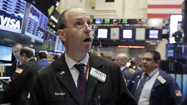 Trader Gordon Charlop works on the floor of the New York Stock Exchange, Wednesday, Feb. 3, 2016. The stock market has given up an early gain and is trading lower at mid-morning Wednesday as investors give a thumbs-down to a number of corporate earnings reports, including steep cutbacks at Yahoo. (AP Photo/Richard Drew)
