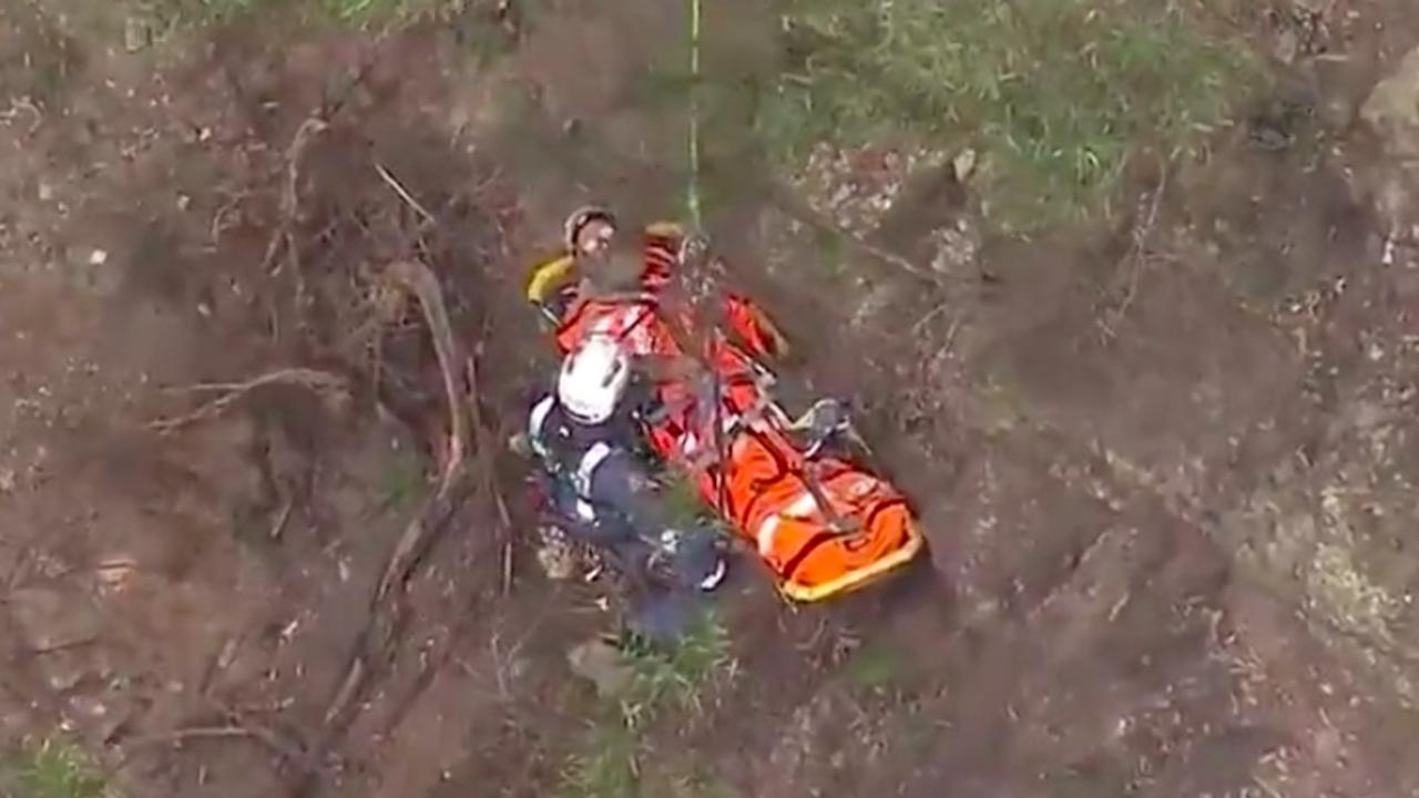 Crews began the difficult task of lowering the man down the cliff face after midday. Picture: 9 News