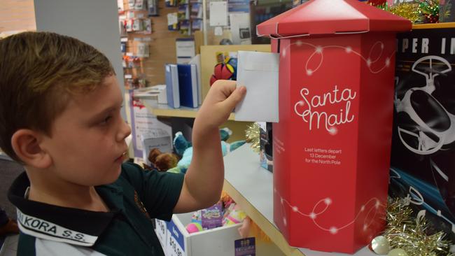 Blake Thomsen sending his Santa letter in Gladstone's Australia Post Office, November 18.