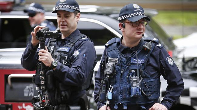 Police filming protesters in Melbourne. Picture: David Caird