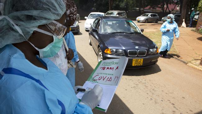 Health workers screen motorists and people visiting a public hospital in Harare, Zimbabwe on Saturday.