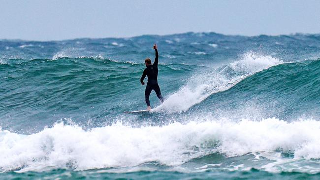 Mick Fanning braves the waves at Kirra beach. Picture: Nigel Hallett