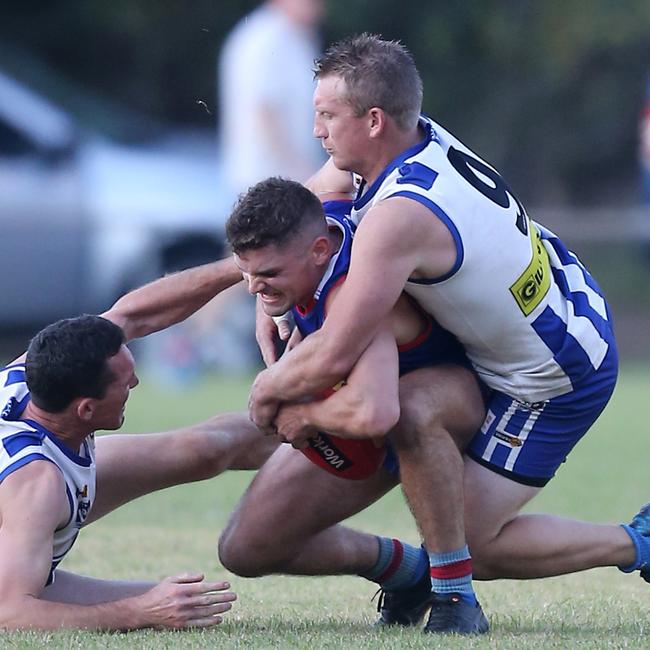 Beechworth’s Campbell Fendyk scraps with two Yackandandah opponents for the ball.