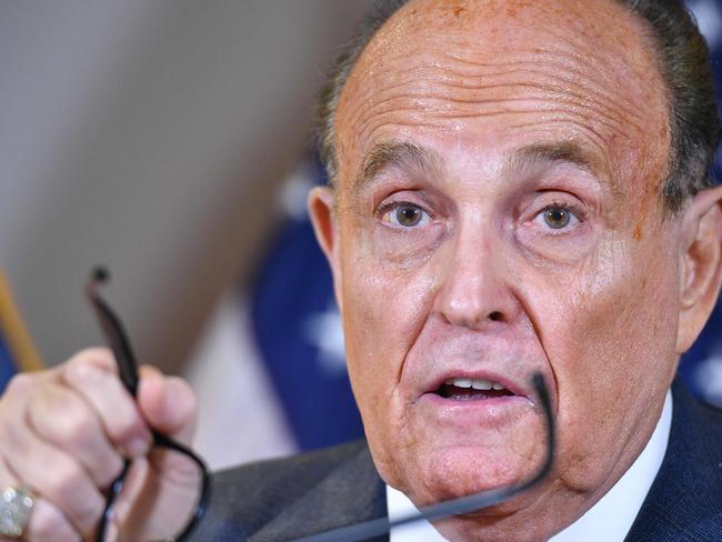 (FILES) In this file photo former President Trump's personal lawyer Rudy Giuliani speaks during a press conference at the Republican National Committee headquarters in Washington, DC, on November 19, 2020. - A voting machine manufacturer sued Rudy Giuliani, the lawyer for former US president Donald Trump, on January 25, 2021 after he claimed the company had cost Trump last November's election. In a defamation lawsuit seeking damages of $1.3 billion, Dominion Voting Systems said Giuliani and other Trump allies had damaged its reputation by alleging its widely used voting machines were part of a "massive fraud" that Giuliani claimed had "fixed the vote" for now-President Joe Biden. (Photo by MANDEL NGAN / AFP)