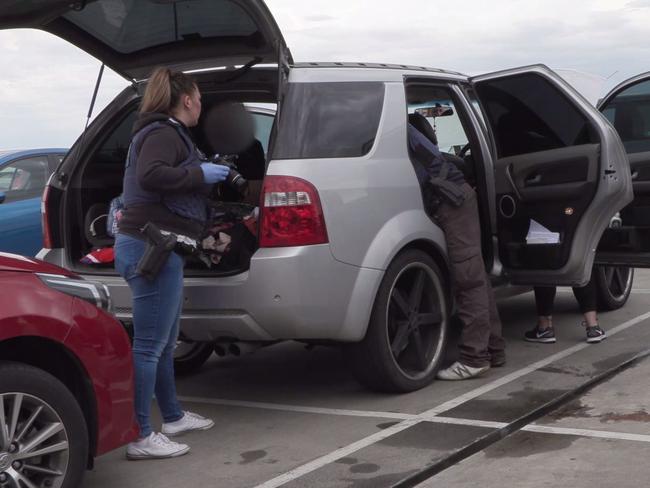 Police search a car during a raid in Melbourne's south on Tuesday. Picture: Victoria Police