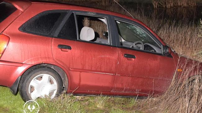 The woman was allegedly bundled into the boot of this red Ford Laser, seen here in wetlands off Salisbury Highway. Photo: SA POLICE