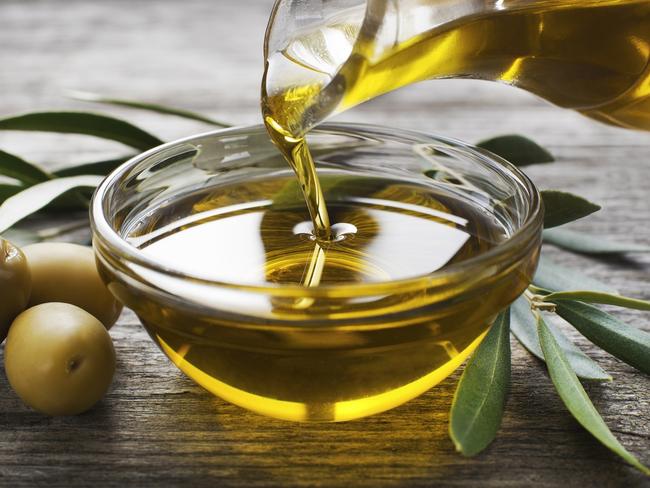 Bottle pouring virgin olive oil in a bowl close up  Picture: istock