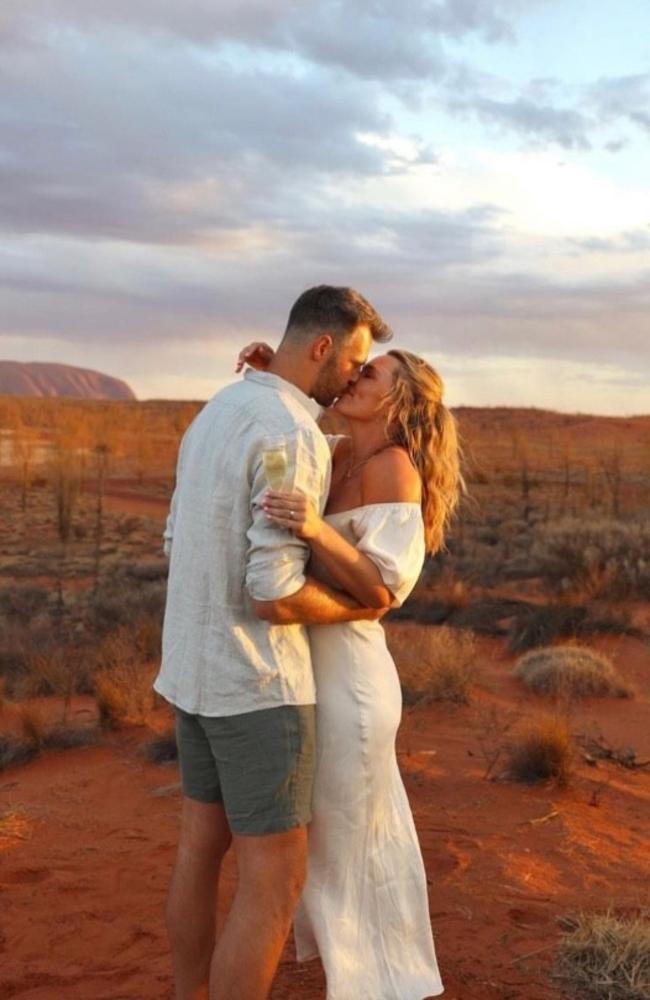 Holmes and Brooksby celebrate their engagement at Uluru. Picture: Supplied