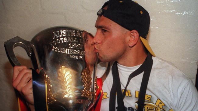 Andrew McLeod with his premiership medal, Norm Smith Medal and Adelaide’s premiership cup in 1997.