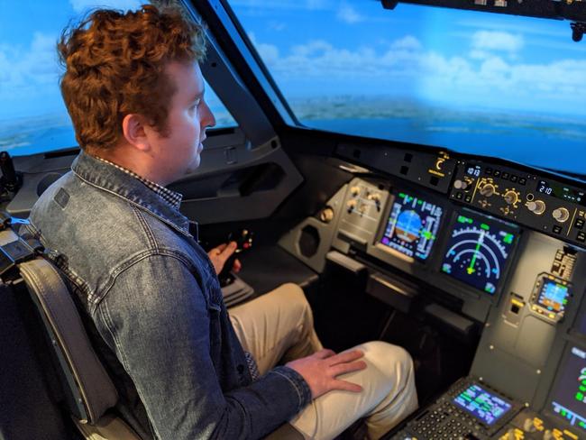 Tobi Loftus has a go on the A320 flight simulator at USQ