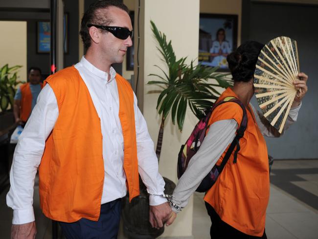 British national David Taylor holds hands with Australian national Sara Connor as they are transferred from Kerobokan prison ahead of their court appearance in Denpasar. Picture: AFP