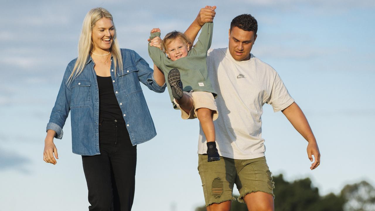 Firebirds star Gretel Bueta pictured with husband Niko and son Bobby, 21 months, is expecting her second child. Picture Lachie Millard