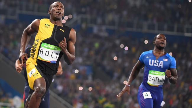 Jamaica's Usain Bolt (L) and USA's Justin Gatlin compete in the Men's 100m Final during the athletics event at the Rio 2016 Olympic Games at the Olympic Stadium in Rio de Janeiro on August 14, 2016. / AFP PHOTO / OLIVIER MORIN