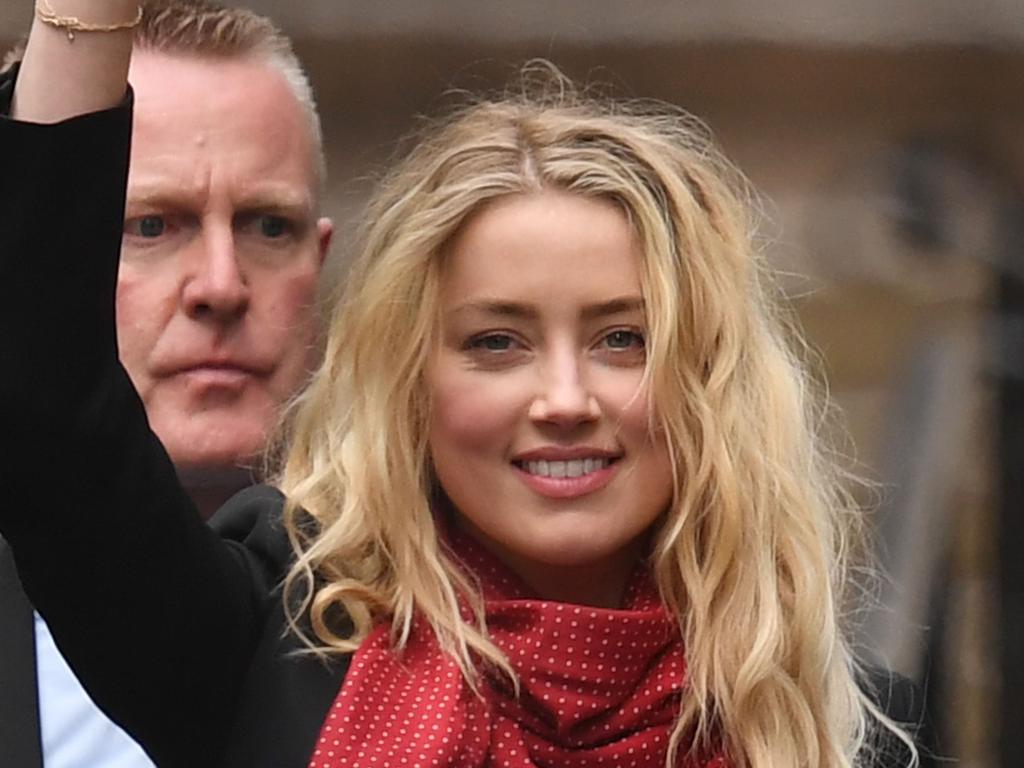 US actress Amber Heard waves as she leaves the High Court in London. Picture: Daniel Leal-Olivas/AFP