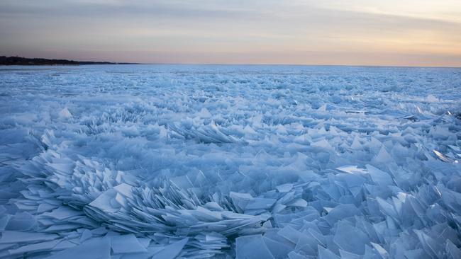 The stacked patterns of blue ice stretch almost as far as the eye can see. Picture: Joel Bissell/Kalamazoo Gazette via AP