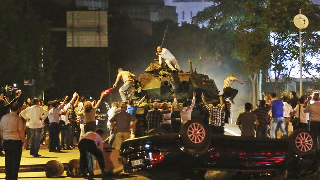 Tanks move into position as Turkish people attempt to stop them, in Ankara, Turkey, early Saturday, July 16, 2016. Turkey's armed forces said it 