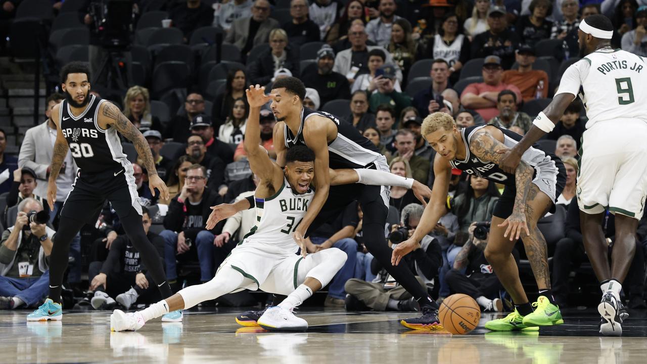 Giannis Antetokounmpo loses control of the ball as he drives on Victor Wembanyama. (Photo by Ronald Cortes/Getty Images)