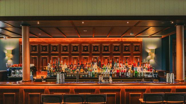 The bar at Club Felix uses restored wood panels from the original Naldham House. Picture: Dexter Kim