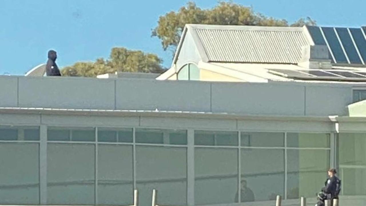 Police are seen with a man on the roof at the Christies Beach Hotel. Picture: Supplied