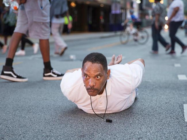 A man lays on the ground after yelling "Don't shoot me" at police during a rally in Dallas. Picture: AFP