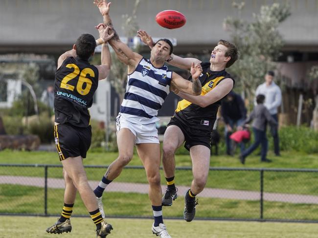 MPNFL: Chelsea’s Mathew Baxter caught between two Tigers. Picture: Valeriu Campan