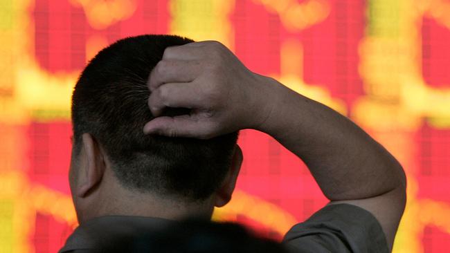 An investor monitors stock prices in front of a board at a stock exchange in Chengdu, southwestern China's Sichuan province on Wednesday, May 30, 2007. Chinese stocks plunged Wednesday after the government raised a tax on share trades, trying to cool a market boom amid growing concerns about a possible bubble. (AP Photo/Color China Photo) ** CHINA OUT **