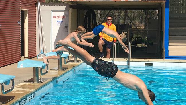 Mount Morgan Pool file photo. Pictured is lifeguard Kaleb Armstrong, Hani, Dublin and Django Camm.