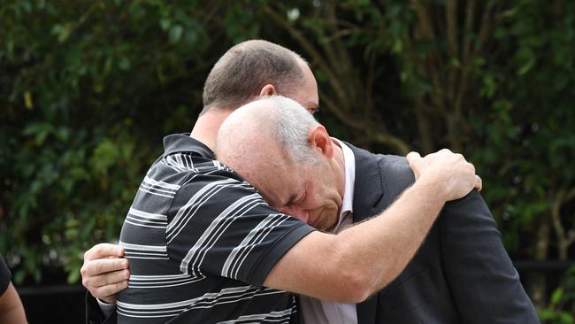 (L-R) Matthew King, the father of Alex King, 19, embraces Cornelius Brosnan, the father of Callum Brosnan, 21, outside the Coroner's Court. Picture:Peter Rae