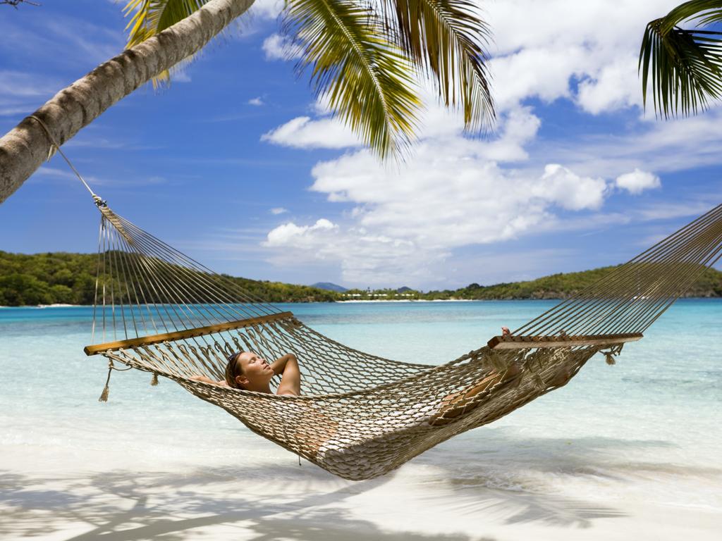 Imagine relaxing on the beach while knowing your spending less than you would be living in the city. Picture: iStock