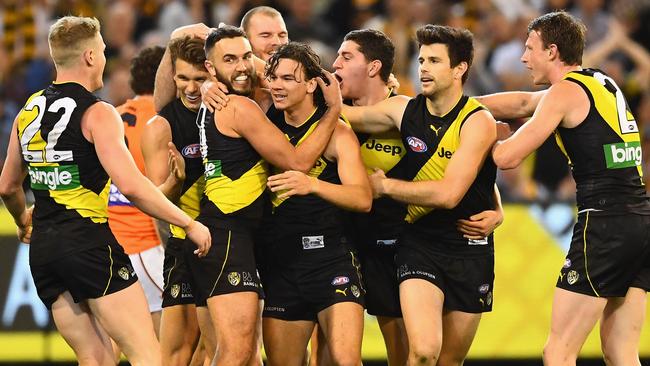 Richmond players congratulate Daniel Rioli after he kicked a goal.