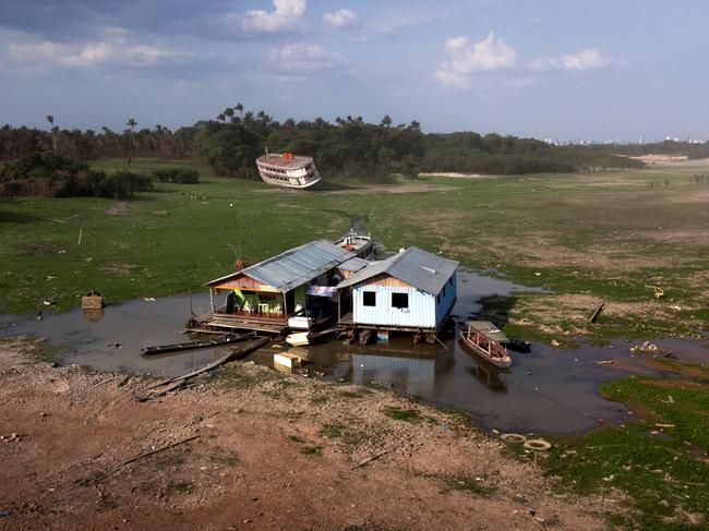 An aerial view of floating houses in a drought-hit harbour in Amazonas, Brazil. The state of Amazonas remains in emergency due to severe droughts caused by climate change, heat and El Niño. Picture: Bruno Zanardo/Getty Images