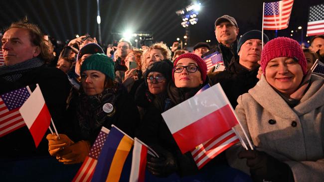 People cheer during the speech of the US President at the Royal Warsaw Castle Gardens in Warsaw on February 21, 2023. (Photo by Mandel NGAN / AFP)