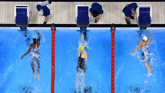 Simone Manuel (left) of the United States touches the wall to win gold in the women's 100m freestyle final ahead of Cate Campbell (middle).