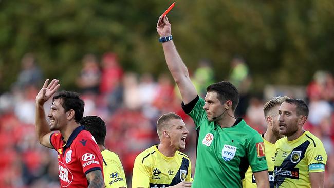 Referee Shaun Evans sends Adelaide United defender Ersan Gulum off early in the match.