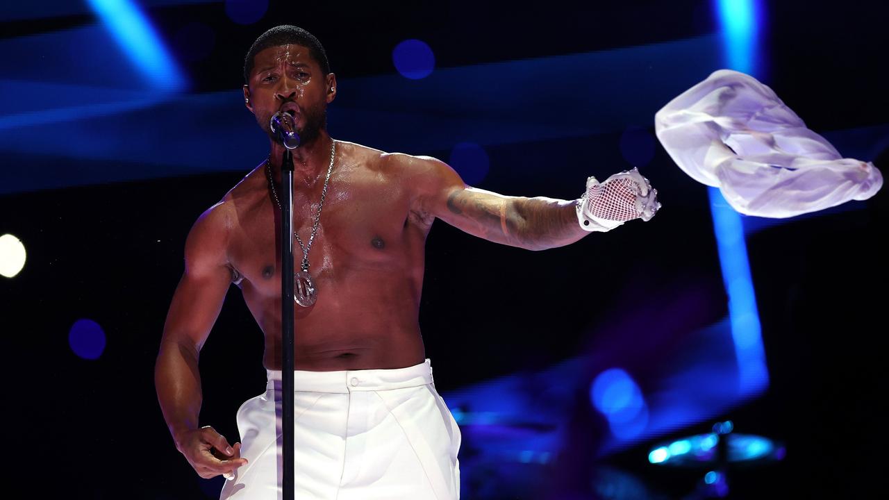 Usher ditches his shirt onstage. (Photo by Jamie Squire/Getty Images)