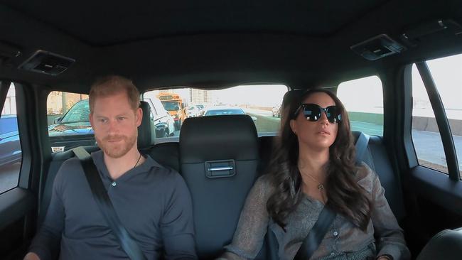 Harry and Meghan are seen in the back of a car in their Netflix docuseries. Picture: Netflix