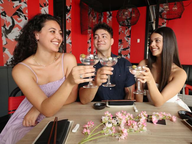 QT Hotels is offering a "throuples" package for Valentines Day. A throuple is a term to refer to three people who are in a relationship with each other. Olivia Startari, Tyson Hutana and Isabella Musso make a toast to the idea. Picture Glenn Hampson