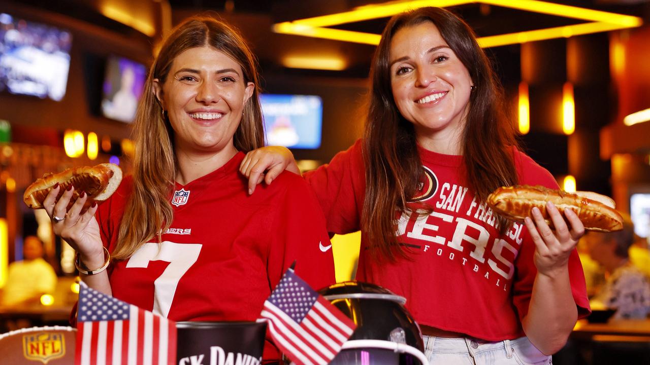 Kailei Ginman and Stephanie Balafa enjoy some hot dogs in the sports bar at The Star before the Super Bowl. Picture: Sam Ruttyn