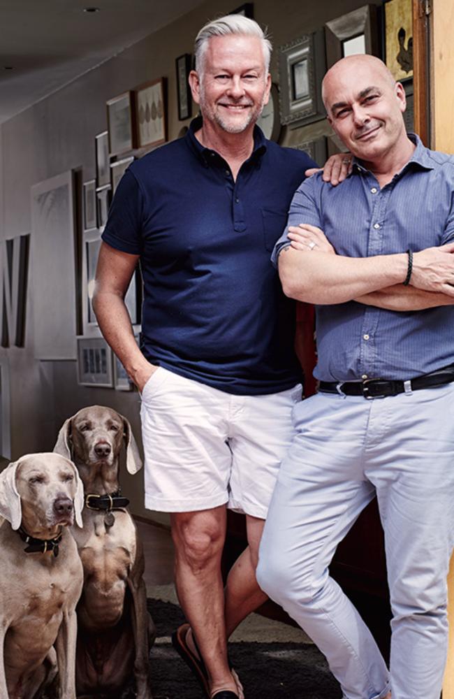 Neale (right) and his partner David at home with their dogs.