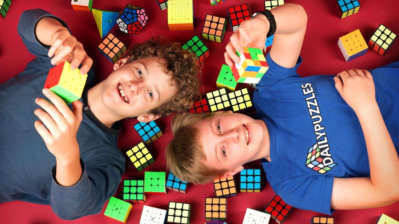 Brisbane teen Charlie Eggins, right, has set a world record at just 14 years old with his 3x3 Blindfolded performance at the National Speedcubing Championships in Queensland. At left is Toby Seufert, 13, who won the non-blindfolded division. Picture: Steve Pohlner