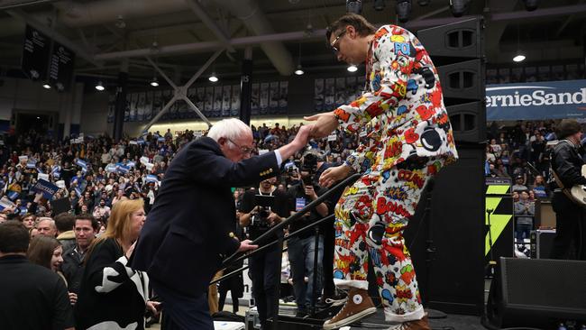 Julian Casablancas, lead singer of The Strokes, helps Bernie Sanders onto the stage at the Whittemore Center Arena in Durham, New Hampshire, on Tuesday. Picture: AFP