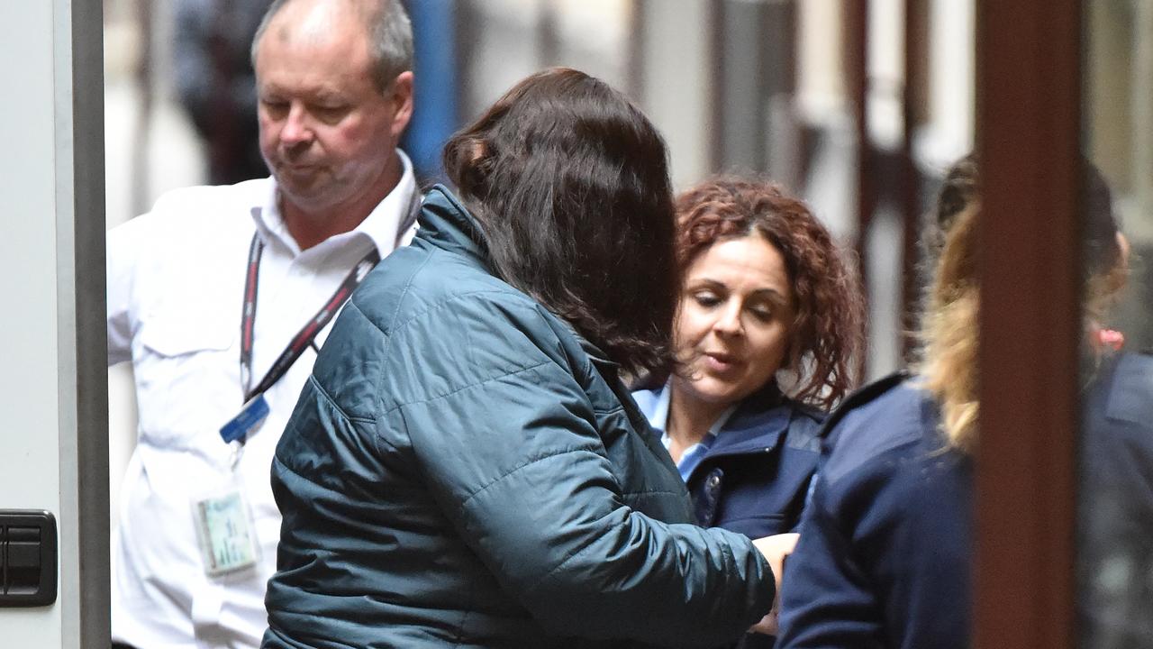 Katia Pyliotis (centre left) has a murder charge against her dropped after she was due to face a fifth trial over the death of a Kew East widower who was beaten to death at his home. (AAP Image/James Ross) NO ARCHIVING