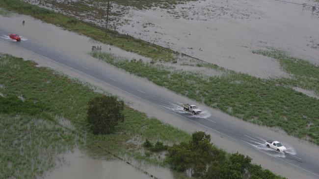Cars travelling north on the Bruce Highway, around the Goorganga Plains, just south of Proserpine which has been surrounded by water after heavy rain. Photo Lee Constable / Daily Mercury