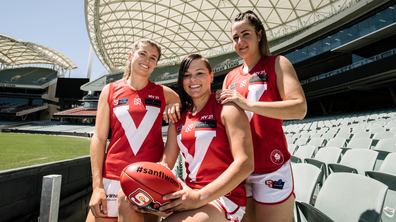 Nadia von Bertouch, Sarah Ellis and Cristie Castle wearing the 2019 Adelaide womenÕs guernseys with ÒMV21Ó in memory of former teammate Maggie Varcoe in Adelaide, Friday, February 15, 2019. (AAP Image/ Morgan Sette)