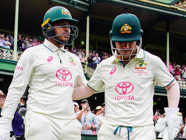 Australian Opening batsmen David Warner and Usman Khawaja embrace before taking the field on the first day of the Sydney Test, David Warner's last test match. Photographer: Tom Parrish