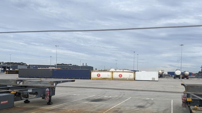 Shipping containers block a truck at a depot on Friday. Picture: Miles Proust