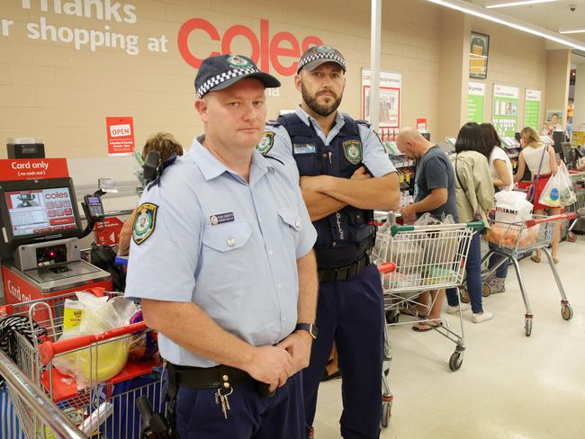 The 12-item rule follows Coles’ crackdown on self-serve check-outs with NSW Police, like Sgt Tony Doherty and Constable Ryan Hall (above) on duty at Coles Erina. Picture: Mark Scott.