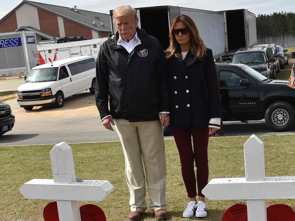 US President Donald Trump and First Lady Melania stand outside Providence Baptist Church March 8, 2019 in Opelika, Alabama, during a tour of tornado-damaged areas. Pic: AFP