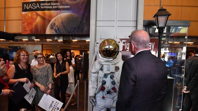 Mr Morrison looks at a replica space suit at the NASA headquarters in Washington DC during a tour on Sunday.